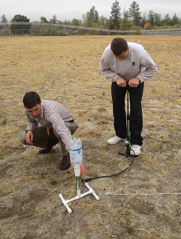 man and youth set up bottle rocket.jpg