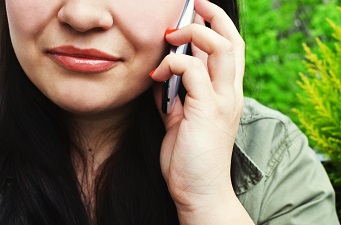 Close up on face of caller on phone