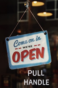Sign on door says "come on in we're open" and "pull handle"