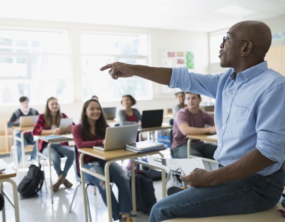 Picture of a teacher instructing their students.