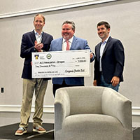Treasurer Read holding a check