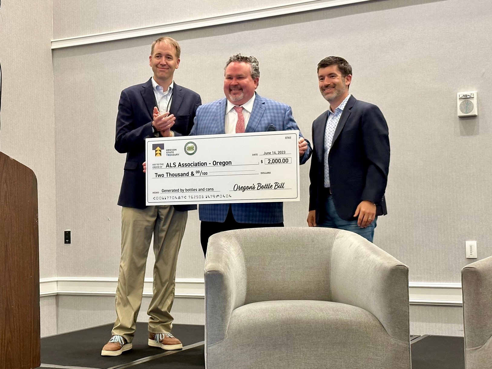 Picture of Treasurer read presenting bottle drop check