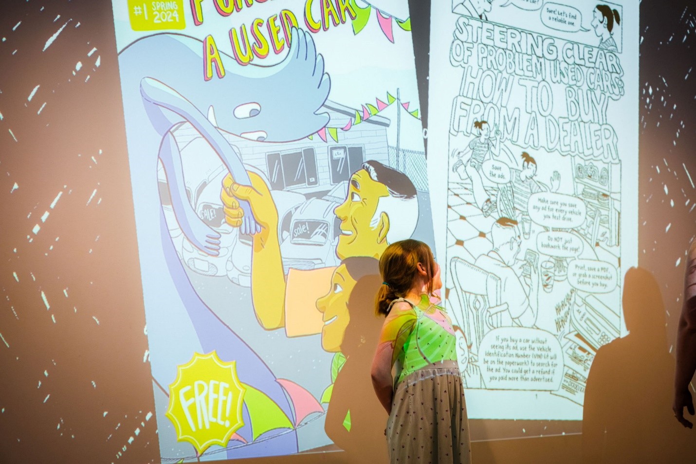picture of a little girl standing in front of comic projection