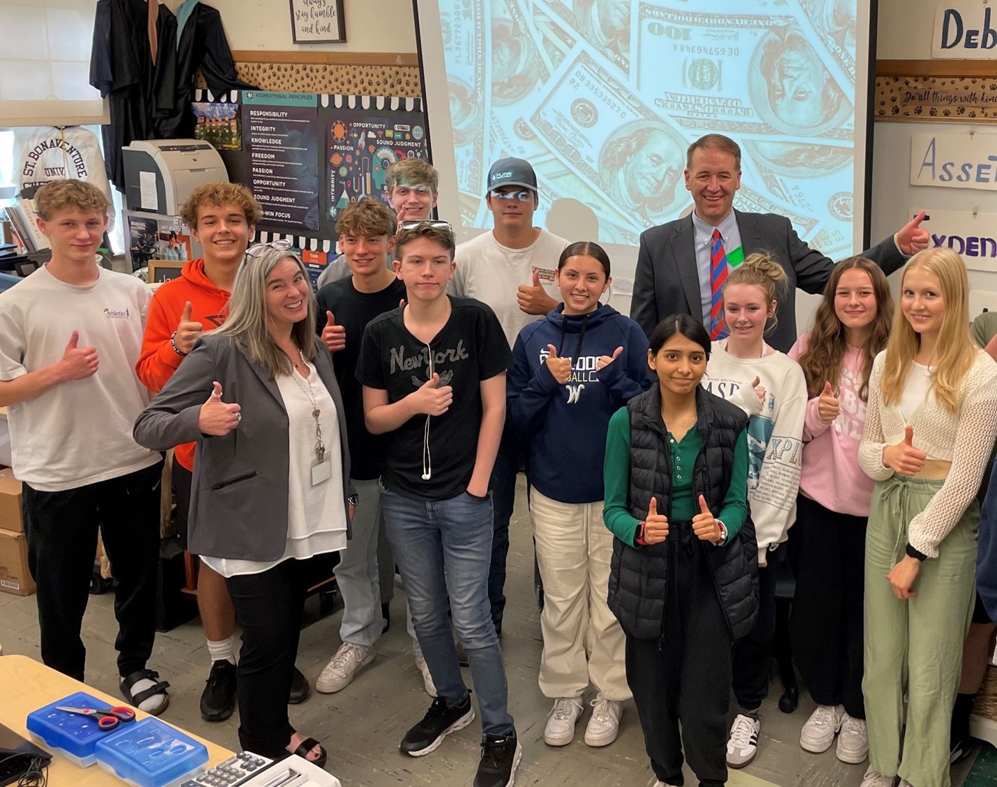 Treasurer read in photo with students and teacher Joey Running