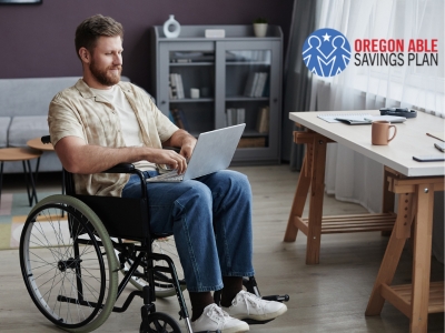 Man in wheelchair using laptop